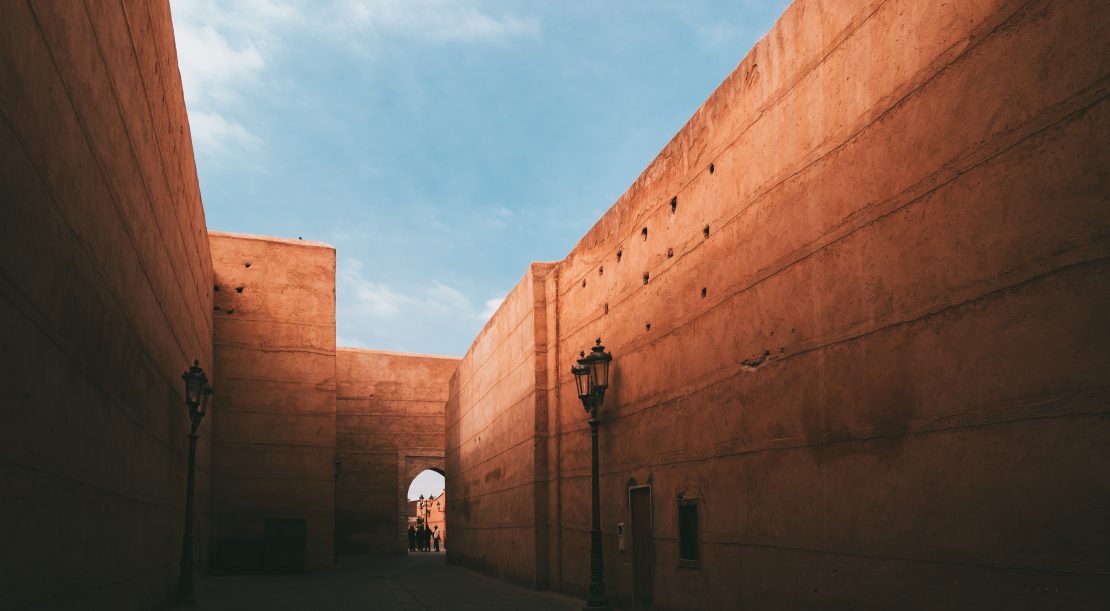 An alley in a Medina of Marrakech under the sunlight and a blue sky in Mor